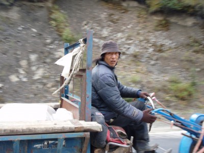 Tibetan man on tractor Too surprised to smile