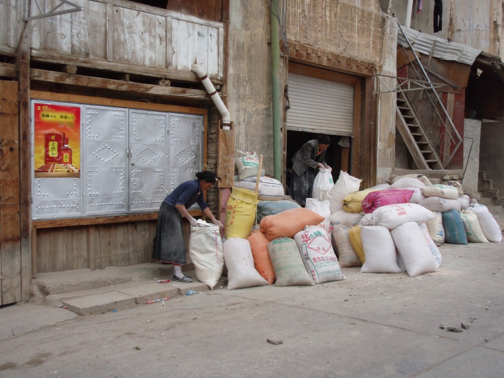 Woman filling sacks Woman filling sacks in SW China